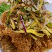 A36. Crispy Catfish Salad ยำปลาดุกฟู · With mango, onion, chili, lime juice and cashew nut. Spicy.