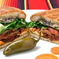Torta Mexicana · Mexican sandwich telera style bread with refried beans, meat of choice, lettuce, tomato and ...