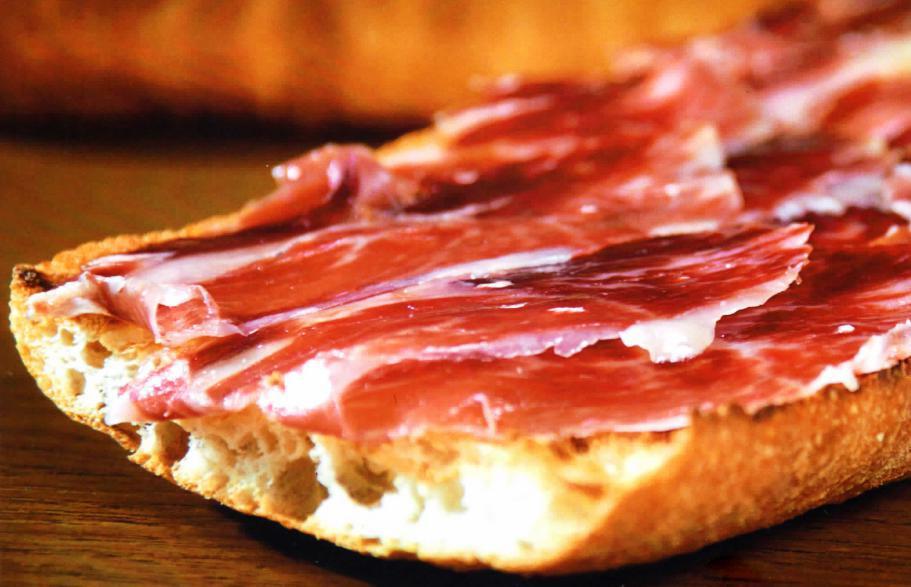 Racion de Pan Cristal a la Catalana · Bread toasted with grated tomato, extra virgin olive oil and Serrano Ham.