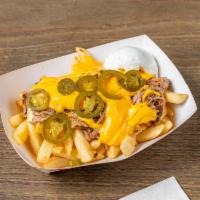 Loaded Fries · Hot crispy steak fries covered in your choice of pulled pork or chopped beef topped with mel...