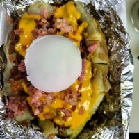 Loaded Baked Potato · Baked Potato perfectly cooked with your choice of Chopped Beef or Pulled Pork topped with Bu...