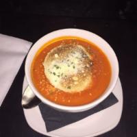 Rustic Tomato Soup · Roasted Italian tomatoes, crouton, Parmesan cheese.