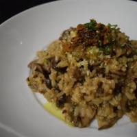 Wild Mushroom Truffle Risotto · With oyster, shiitake and hen of the wood mushrooms, and black truffle butter.