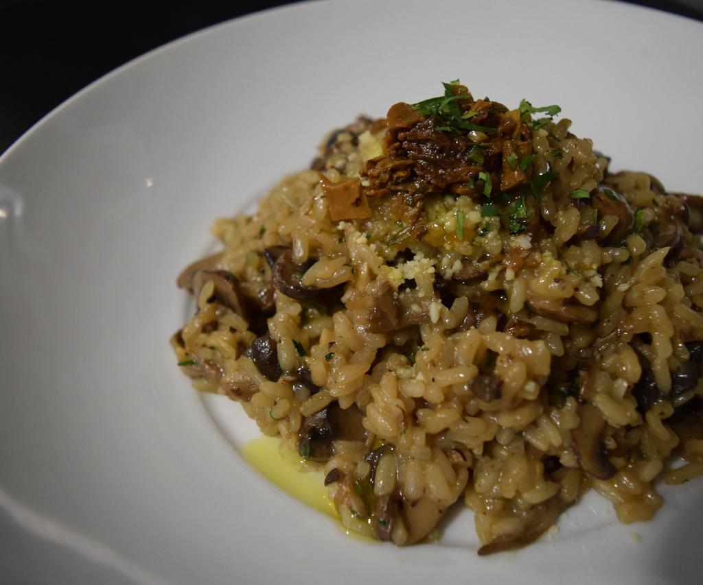 Wild Mushroom Truffle Risotto · With oyster, shiitake and hen of the wood mushrooms, and black truffle butter.