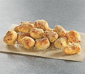Parmesan Bread Bites · Oven-baked, bite-size breadsticks lightly sprinkled with Parmesan-Asiago cheese and seasoned with garlic and more Parmesan. Perfectly delicious for sharing.