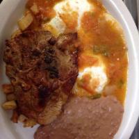 Huevos Rancheros with Pork Chop · 2 Eggs, 1 Pork Chop, Breakfast Potatoes, Refried Beans, and Tortillas. 