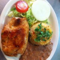 Pechuga Rellena · Chicken Breast stuffed with Cheese and Ham. Served with Salad, Rice, Beans, and Tortillas 
