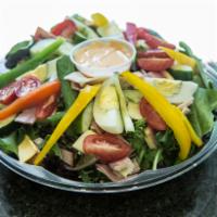 Traditional Chef's Salad · Turkey, ham, Swiss and American cheese, hard boiled egg and cucumber over mixed greens.