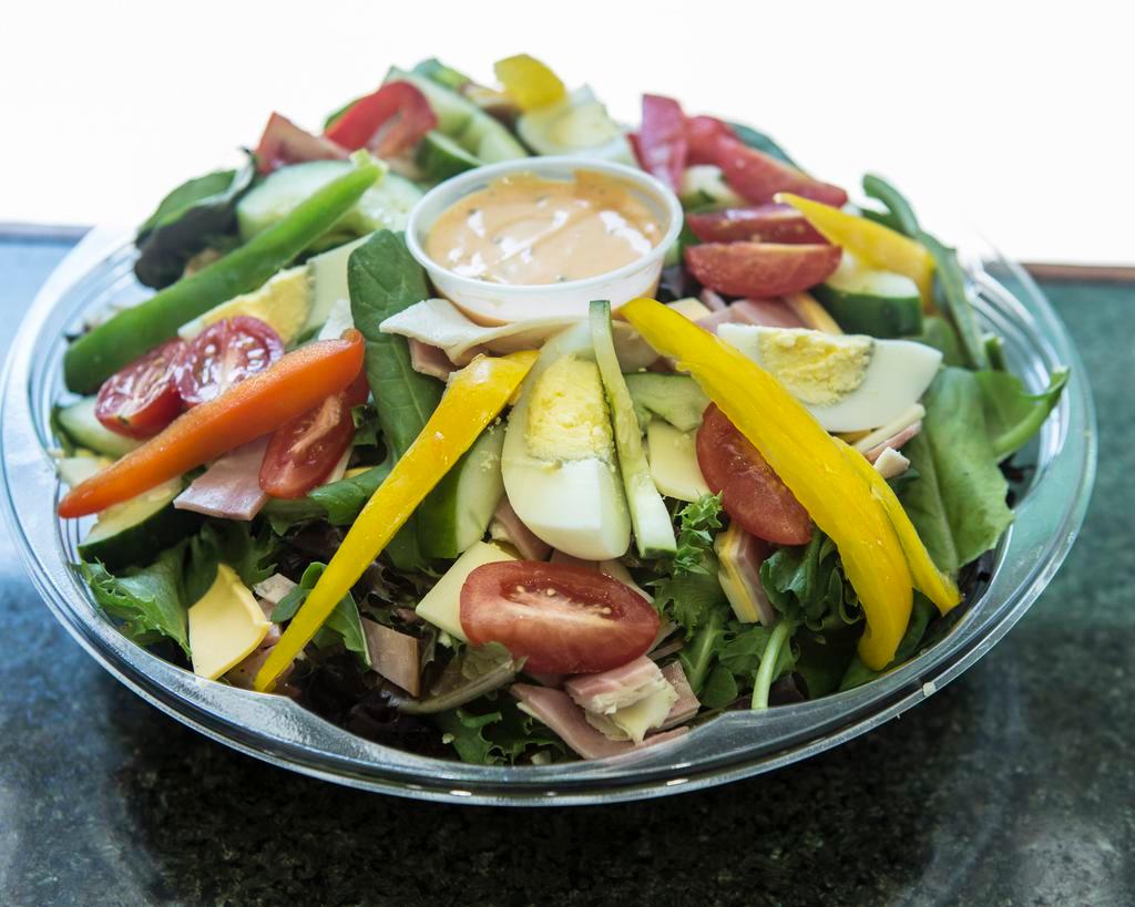 Traditional Chef's Salad · Turkey, ham, Swiss and American cheese, hard boiled egg and cucumber over mixed greens.