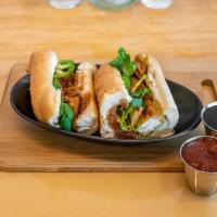 Fried Tofu Sandwich · Toasted baguette served with tofu, butter spread, pickled carrots and daikons, cucumbers, ja...