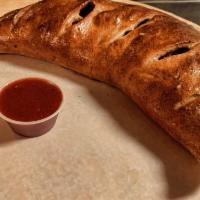 Calzone Stromboly · Ricotta cheese, mozzarella blend, and a side of marinara sauce.