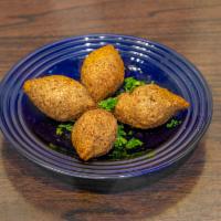 Kibbeh Balls · 1 piece. Oval shaped bulgur cones stuffed with ground lamb, nuts and onions.