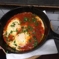 Shakshuka · 2 eggs cooked in a mildly spicy tomato sauce with chili peppers and onion. Cooked and served...