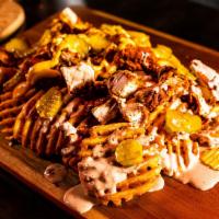 4. Cluck it Up Fries · Waffle fries topped with chicken bits, pickles, and a choice of cheese sauce or comeback sau...
