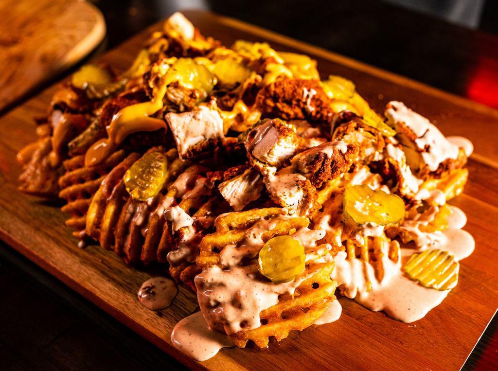 4. Cluck it Up Fries · Waffle fries topped with chicken bits, pickles, and a choice of cheese sauce or comeback sauce or 1/2 and 1/2.