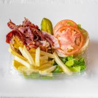 Bacon Cheese burger  · Cheese burger, bacon, green leaf lettuce, tomatoes on a seeded bun 