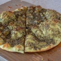 Zaatar Flatbread Pizza · Thyme mixed with olive oil topped on fresh baked flatbread.
