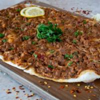 Lahmajun · Meat flatbread. Hand rolled thin crust with fresh ground beef and chopped vegetables on top ...