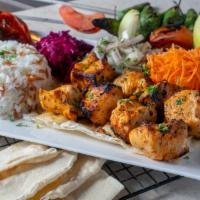 Chicken Tikka · Shish Tawooq. Skewers of fresh halal marinated chicken breast grilled over charcoal, served ...