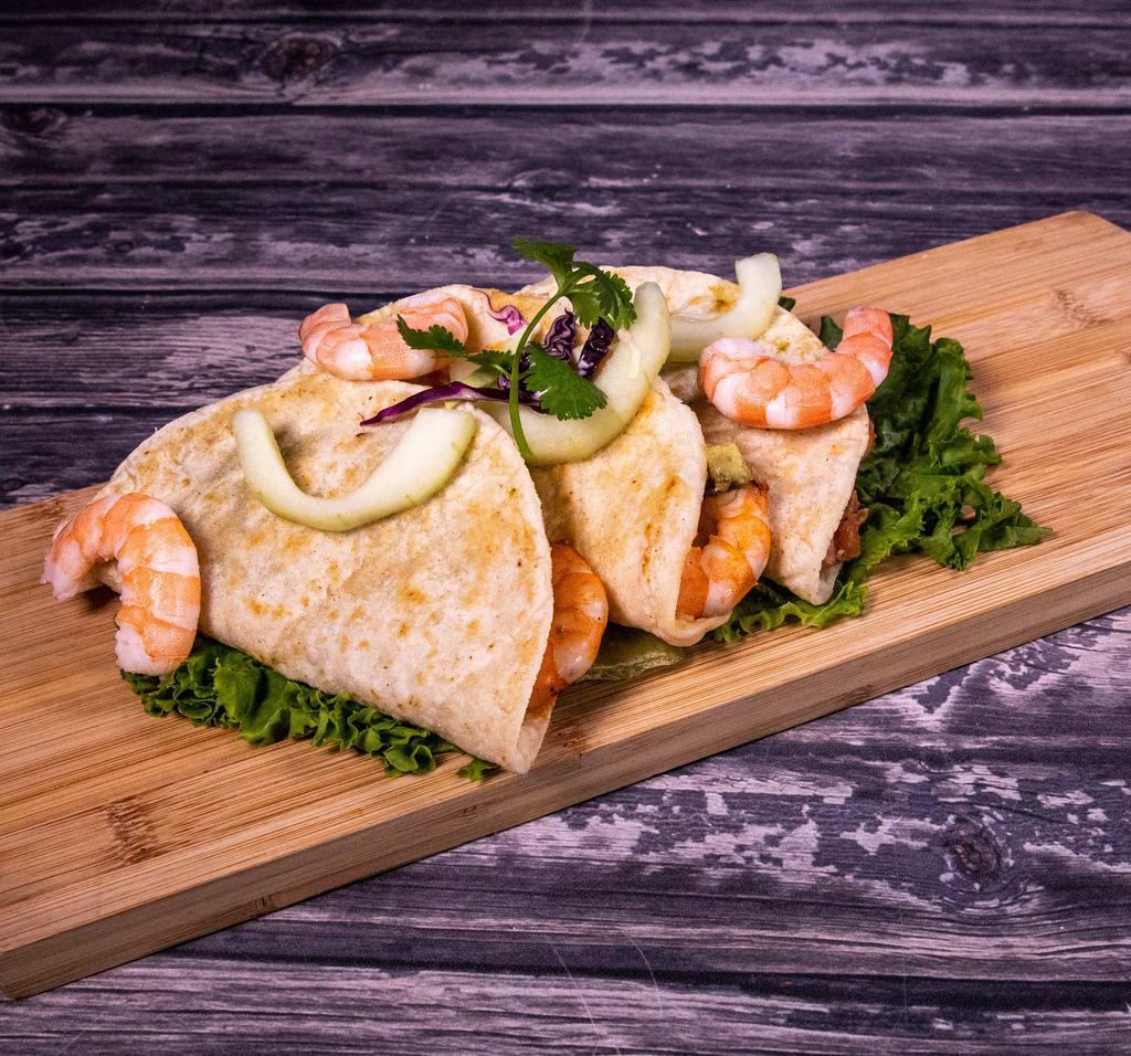 Quesadilla Azteca · Delicious shrimp quesadillas stuffed with huitlacoche, refried beans, and avocado, served with a creamy chipotle sauce.