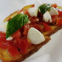 Bruschetta al Pomodoro  · Classic Italian toasted country bread topped with chopped tomatoes, basil and fresh mozzarel...