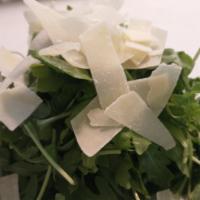 Rughetta Salad · Arugola salad , shaved Parmesan cheese  in a lemon dressing.