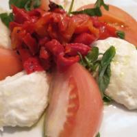 Caprese Salad · fresh mozzarella cheese, with slices tomatoes and roasted peppers topped with fresh basil, d...