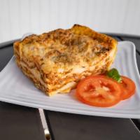 LASAGNA BOLOGNESE · Homemade beef lasagna baked with mozzarella and parmesan cheese