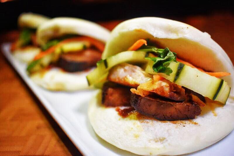 Pork Bao Buns · Tender pork belly, hoisin glaze, pickled cucumber served on a Asian bao bun.