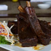 Pork Spare Ribs · Fall-off-the-bore tender barbecued pork ribs with our own special sauce.