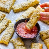 Bread Sticks  · 8 sticks. Topped with melted butter, garlic, and Parmesan, includes side of zesty red sauce ...