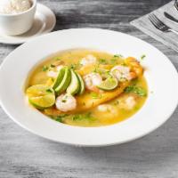 Corvina en Salsa de Camaron · Braised corvina in a shrimp pepper, onion sauce with white rice or green plantain.