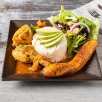 Seco de Pollo · Braised chicken stew served with white rice, sweet plantain, and mixed greens.