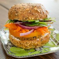 Hemp Sunshine Burger (V) · 100% Organic. 
Quinoa, red lentils, sunflower seeds and hemp seeds. Served on a bun with avo...