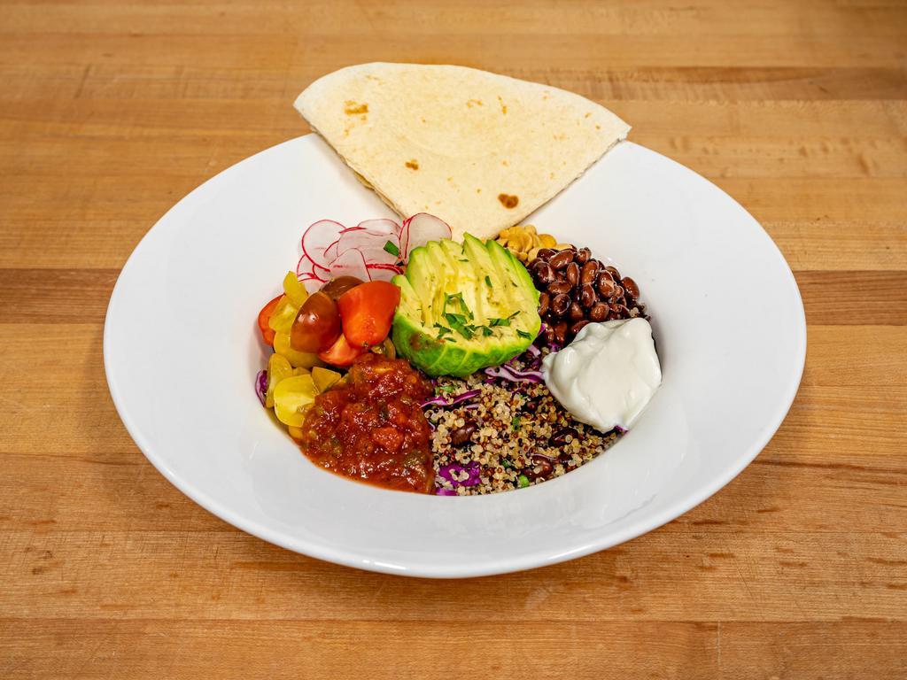 Nacho Bowl Lunch · Tomato quinoa salsa and black beans accompanied by irresistible corn chips topped with tangy coconut sour cream and avocado. Gluten free.