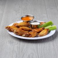 Chicken Wings · 10 tasty jumbo wings tossed in your choice of sauce. Served with celery and bleu cheese dres...