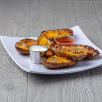 Potato Skins · Half skins loaded with mixed cheeses and bacon. Served with sour cream.