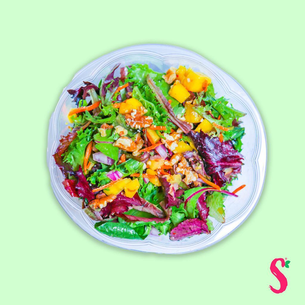 Thai Mango Salad · Scrumptious vegetarian-friendly salad made with mango, carrots, red onion, walnuts, and mixed with spicy Thai peanut dressing.