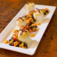 Peppered Bacon Deviled Eggs · With sriracha aioli sauce and black bean and roasted corn salsa