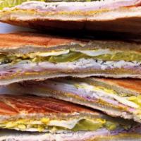 Turkey Cubano Panini · Oven gold turkey and turkey ham with Swiss cheese pickles and spicy mustard