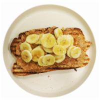 PB Toast · Melted peanut butter with sliced bananas and strawberries, and a dash of organic honey.