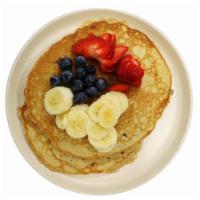 Sweet Potato Pancakes · 2 stack pancakes topped with blueberries, banana and strawberries. 