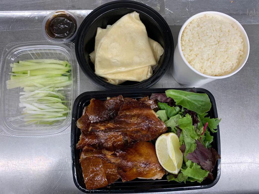 1/2 Perking Duck · Seasoned Peking Duck Slowly grilled until crispy and golden, with meat carved separating the delicate crispy skin  from the tender meat. Served w. Pancake, spring onions,cucumber and Peking Duck sauce. Served w. Rice