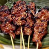 Pork on a Stick · Moo ping. Sweet and savory marinated pork on a stick served with sticky rice.