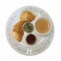 Vegetable Samosa · Indian pastries filled with potato's, peas and spices served with mint and tamarind sauce.