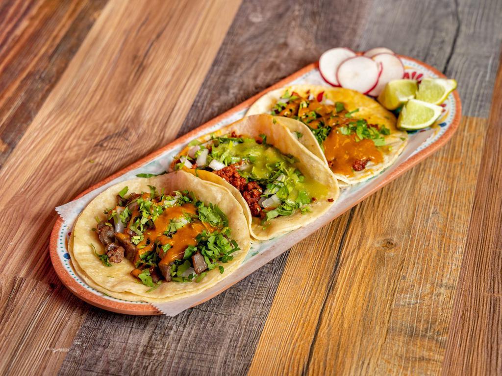Tacos · Stuffed with cilantro, onions (cebolla), guacamole, lemon (limon), and radish (rabano).