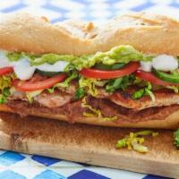 Tortas · Mexican sandwich stuffed with beans (frijoles), lettuce (lechuga), onions (cebolla), tomatoe...