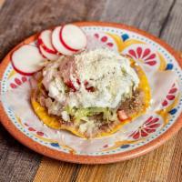 Tostadas · Flat crunch tortilla topped with frijoles (beans), queso (cheese), lechuga (lettuce), tomate...