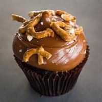 Caramel Crunch Cupcake · Chocolate cake with caramel frosting topped with sea salt and pretzels.