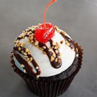 Hot Fudge Sundae Cupcake · Chocolate cake with our signature buttercream frosting, roasted pecans, hot fudge, and a che...